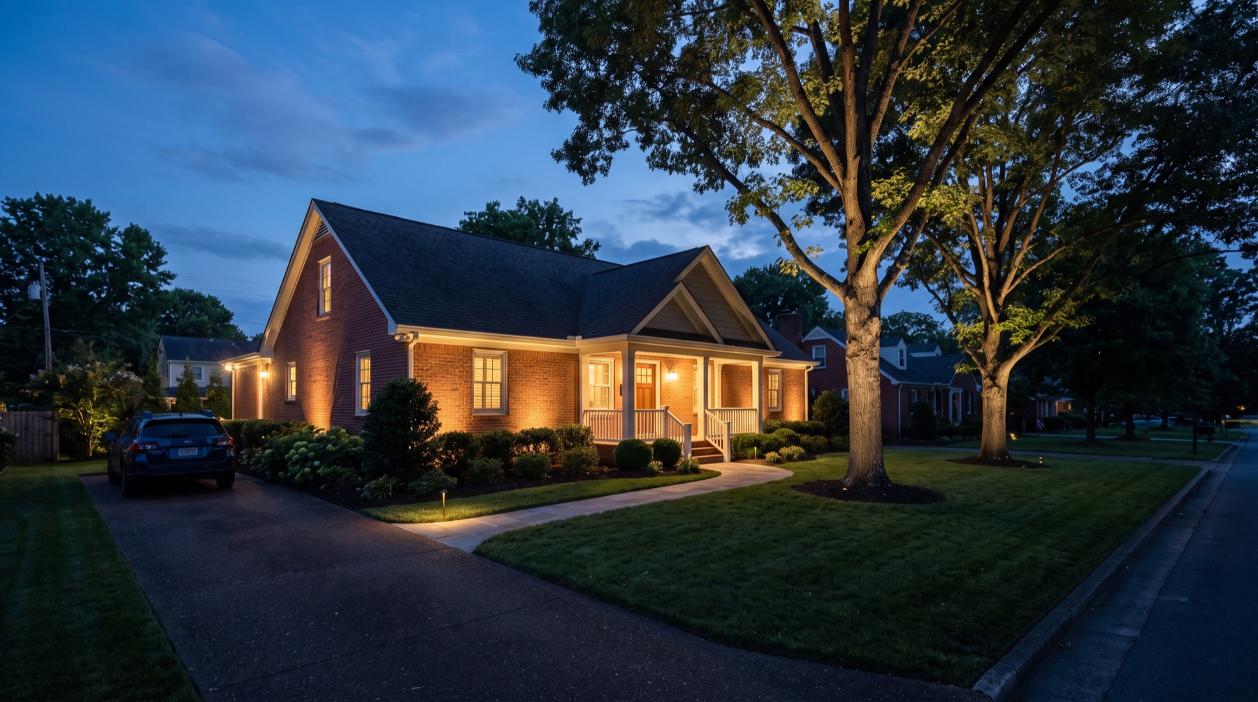 Concept: three-quarter view of a brick home with exterior lighting
